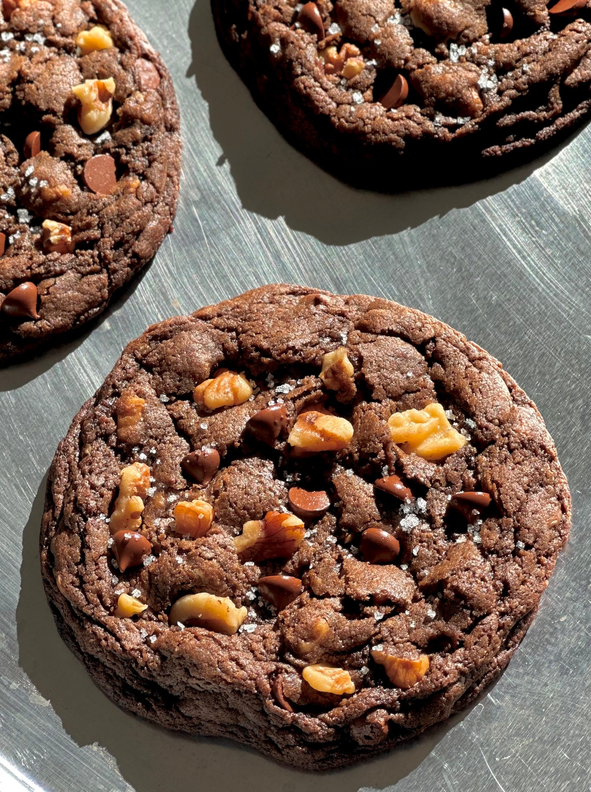 Rich, fudgy, and irresistibly decadent.

This double chocolate walnut cookie is a bold fusion of deep cocoa and molten chocolate chunks,

balanced by the earthy crunch of toasted walnuts.

Crisp on the edges, soft at the center, every bite is a rush of warmth, texture, and pure satisfaction.

Not just a cookie - an experience 